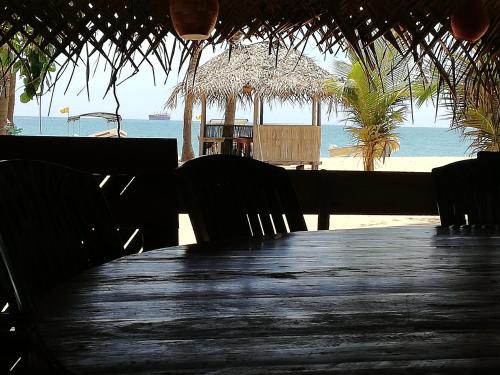 a table with chairs and a view of the beach at Dolphin Village in Kalpitiya