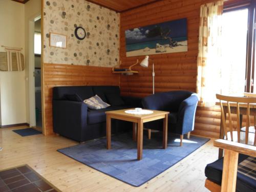 a living room with a couch and a table at Söderö Stugby in Finström