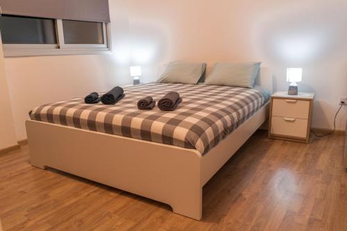 a bedroom with a bed with two pairs of shoes on it at Cozy Flat City Center in Nicosia