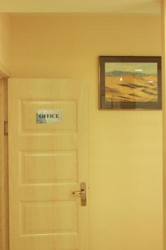 a door with a sign that reads office next to it at Khongor Guest house & Tours in Ulaanbaatar