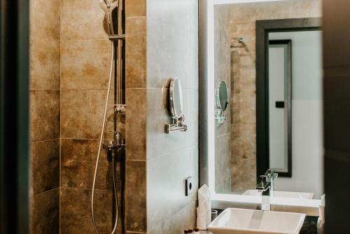ein Bad mit 2 Waschbecken und einer Dusche in der Unterkunft HOTEL HARTEN business & international in Kursk