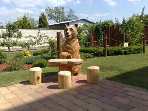 a statue of a bear sitting on a bench at Ubytovani U Kulky in Kyjov