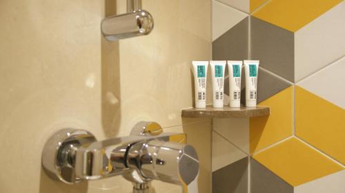 a shower with a bunch of toothbrushes on a shelf at Shama Island North in Hong Kong