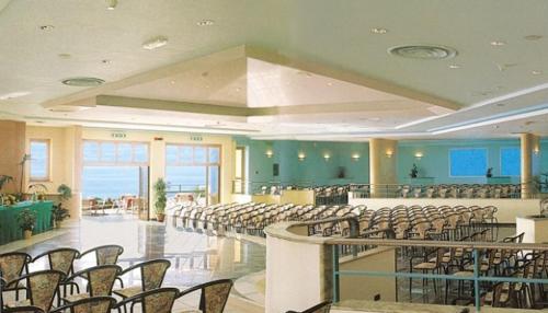 a large room with rows of chairs and tables at Hotel Club San Diego in Maratea