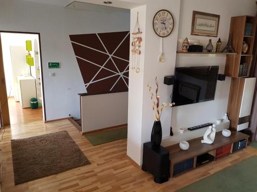 a living room with a television and a vase on a table at A&T Apartment in Zaprešić
