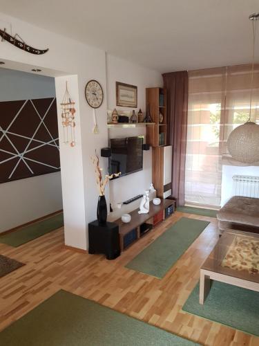 a living room with a couch and a tv at A&T Apartment in Zaprešić