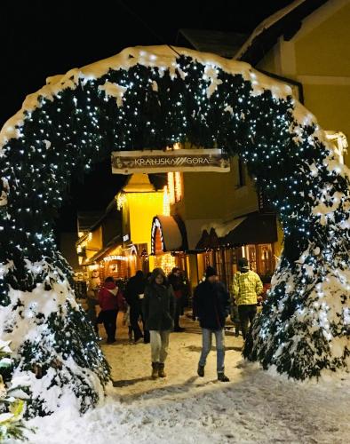 a group of people walking down a street at night at Kotnik Superior Boutique Hotel in Kranjska Gora