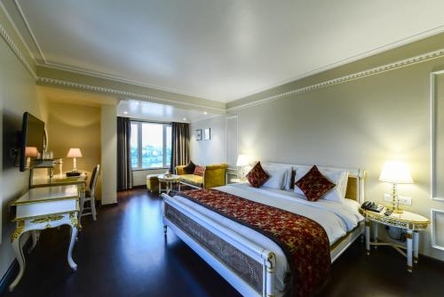 a hotel room with a large bed and a window at Lemon Tree Premier “The Atrium” Ahmedabad in Ahmedabad