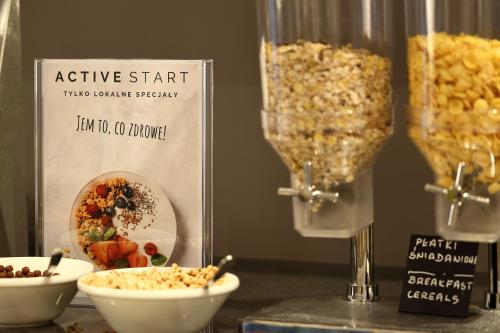 a table topped with bowls of food and a blender at Active Hotel in Wrocław
