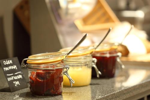 a group of jars of jam on a counter at Active Hotel in Wrocław