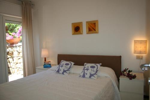 a bedroom with a bed with two pillows on it at Villa Panorama in Diano Marina