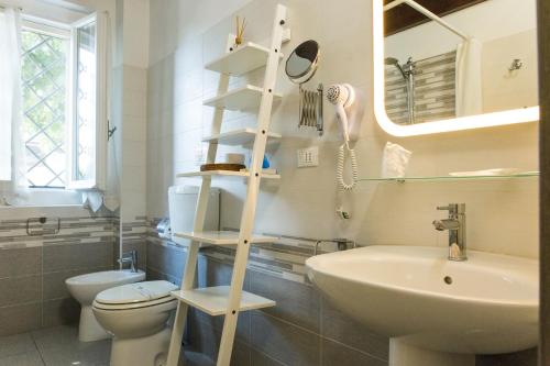 a bathroom with a white toilet and a sink at Country Resort Modena in Modena