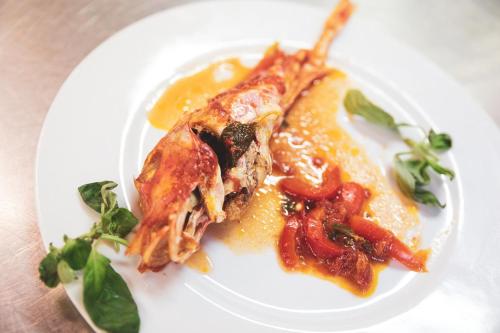 a white plate with a piece of food on it at Hotel Venezia New in Vasto