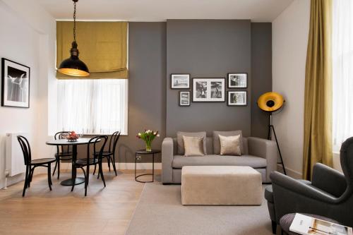 a living room with a couch and a table at Nevern Place by Supercity Aparthotels in London