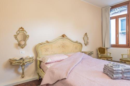 a bedroom with a large bed and a window at Ca de le Colonnette - St Marks Square in Venice
