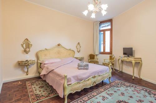 a bedroom with a bed and a television in it at Ca de le Colonnette - St Marks Square in Venice