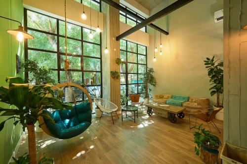 a living room filled with furniture and plants at Blue Bottle Boutique Hotel in Thessaloniki