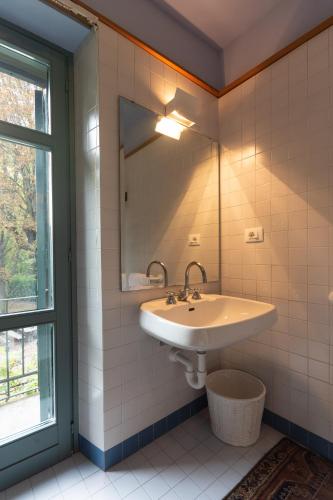 a bathroom with a sink and a mirror at Moleloca - Villa Pandora in Turin