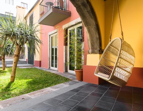 a swing hanging from the side of a house at Castanheiro Boutique Hotel in Funchal