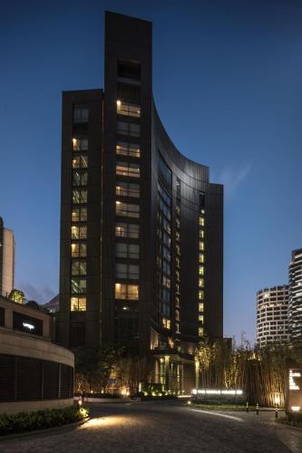 a large building with lights in front of it at The Middle House in Shanghai