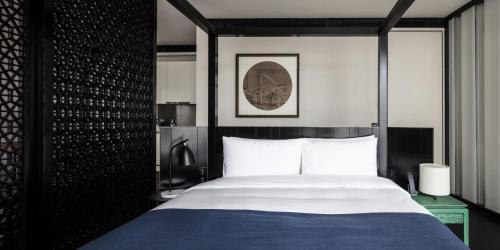 a bedroom with a bed with a blue and white bedspread at The Middle House in Shanghai