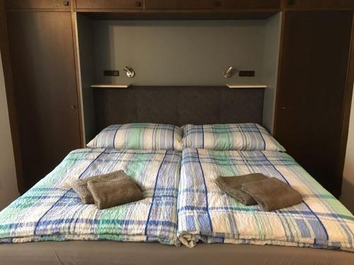 a bed with two pillows on top of it at Haus Alpenkönig Top 17 in Bad Gastein