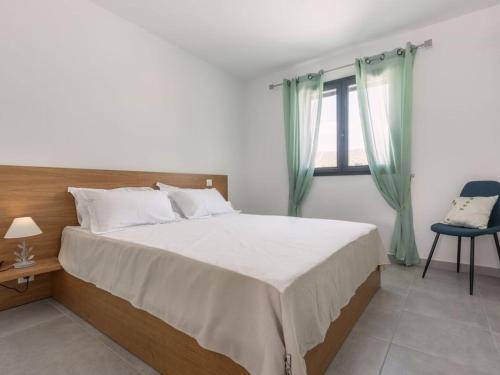 a bedroom with a large bed and a window at Le Domaine De Marie in Palasca