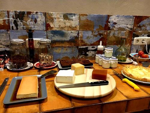 a table with cheeses and other foods on it at Casa Rural Cuny in Casau