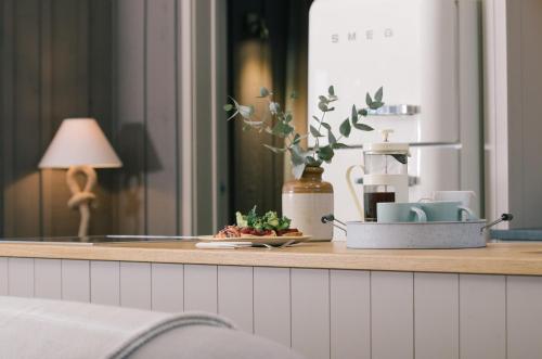a kitchen counter with a tray of food and a lamp at Retreat East in Ipswich