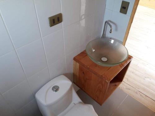 a bathroom with a sink and a toilet at Acuarela minicasas con piscina en Lago Vichuquen in Vichuquén