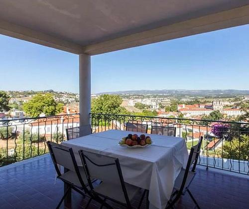 a table with a bowl of fruit on a balcony at Stunning view Alcobaça in Alcobaça