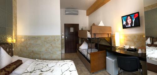 a hotel room with a bed and a desk in it at Hotel Vogelweiderhof in Salzburg