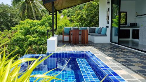 a swimming pool in the backyard of a house at The Plantation Koh Tao in Koh Tao