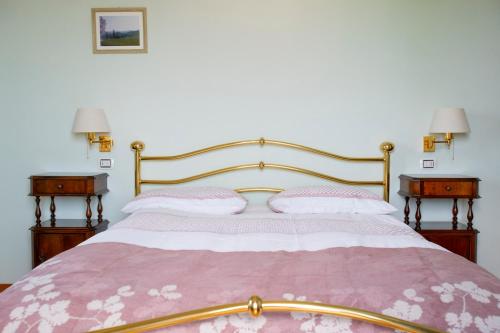 a bedroom with a large bed with two night stands at Il Giardino dei Frati in Roncofreddo