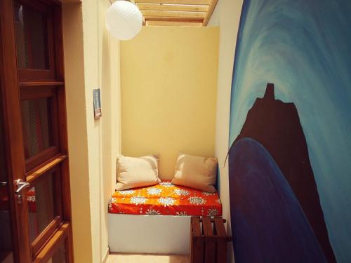 a small room with a bed in the corner at Casa Strela B&B Tarrafal in Tarrafal