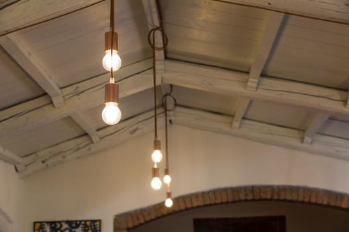 a group of lights hanging from a ceiling at Country Resort Modena in Modena