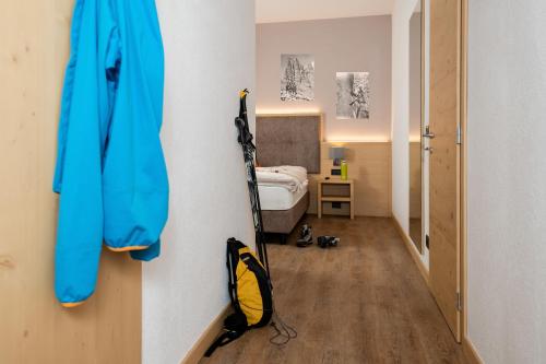 a room with a room with a bed and skis on a wall at GARNI' Margherita in Predazzo