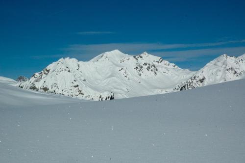 a snow covered mountain in the distance with snow on it at Haus Kinsperger in Klösterle am Arlberg