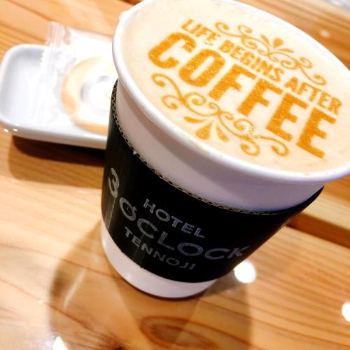 a cup of coffee sitting on top of a table at Hotel 3 O'Clock Tennoji in Osaka