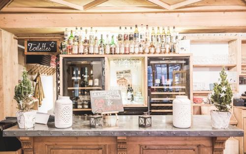a bar with a lot of bottles of alcohol at Lifestyle Rooms & Suites by Beau-Séjour in Champéry