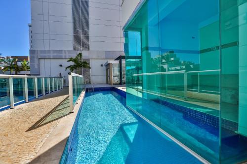 a large swimming pool in a large building at Jade Hotel Brasília in Brasília