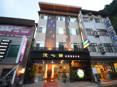 a building with a store in front of it at Xi Xin Guan Hot Spring Resort in Baihe