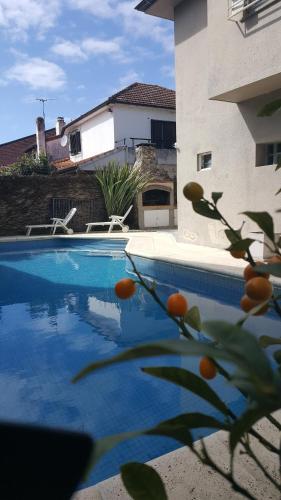 a swimming pool in front of a building at Lo de Lala B&B con Energía Solar in Acassuso