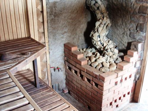 a brick oven with a stack of bricks on a wall at Jaun-Ieviņas in Rauna