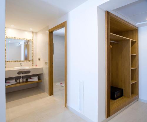 a bathroom with a sink and a mirror at My Way Luxury Ibiza Studio - AB Group in Playa d'en Bossa