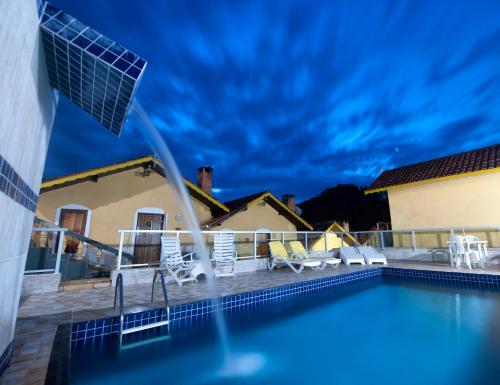 a view of a swimming pool from a house at Pousada Bela Vista in Monte Verde