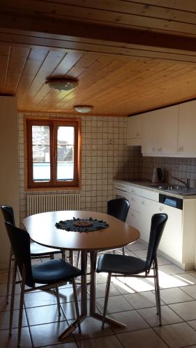 a kitchen with a table and chairs in a kitchen at Apartment Astrid in Münster