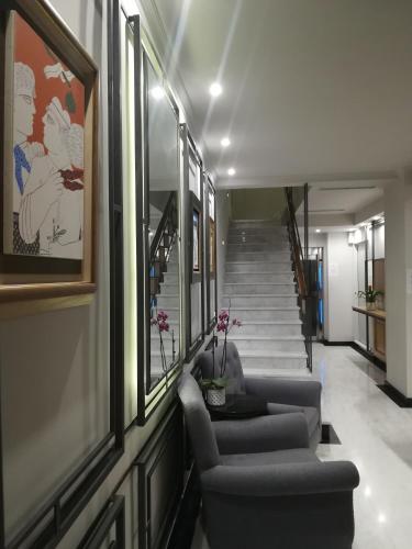 a hallway with couches and stairs in a building at Amaryllis in Nafpaktos
