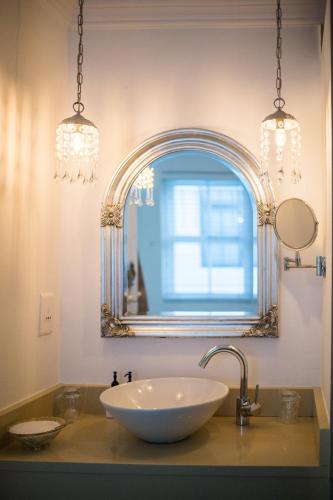 a bathroom with a sink and a mirror at Batavia Boutique Hotel in Stellenbosch