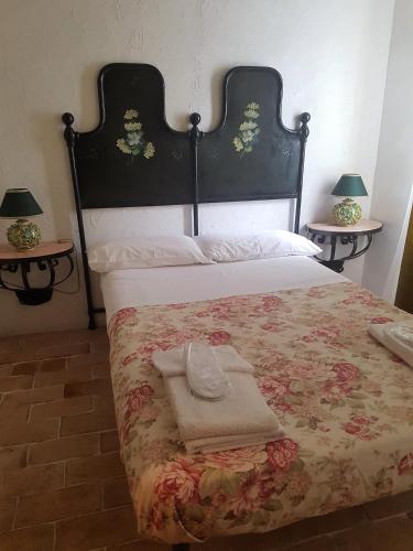 a bedroom with a large bed with a large headboard at Residenza Villa Spagnola in Parghelia